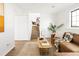 Cozy living room with stairway, door, and light brown leather sofa with bright accent pillow at 10024 Holland Ct, Broomfield, CO 80021