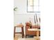 Living room detail showing corner of a leather sofa, side table, decor, and window at 10024 Holland Ct, Broomfield, CO 80021