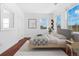 Comfortable bedroom with wood floors, large windows, and closet space offering a relaxing retreat at 1204 S Balsam Ct, Lakewood, CO 80232