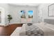 Comfortable bedroom with wood floors, large windows, and closet space offering a relaxing retreat at 1204 S Balsam Ct, Lakewood, CO 80232