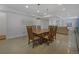 Spacious dining room featuring a large wooden table with seating for eight and modern pendant lighting at 1204 S Balsam Ct, Lakewood, CO 80232