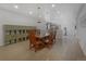 Open dining area with a large table, built-in shelves, and access to a workout area at 1204 S Balsam Ct, Lakewood, CO 80232