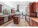 Modern kitchen with stainless steel appliances, center island, and open layout to the living area at 1204 S Balsam Ct, Lakewood, CO 80232