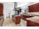 Well-equipped kitchen with a central island, stainless steel appliances, and a bright window at 1204 S Balsam Ct, Lakewood, CO 80232