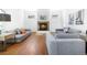 Comfortable living room featuring modern sofas, neutral decor, and a cozy fireplace at 1204 S Balsam Ct, Lakewood, CO 80232