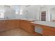 Main bathroom featuring double vanity, expansive counter space, and walk-in closet providing convenience and storage at 1204 S Balsam Ct, Lakewood, CO 80232