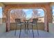 Inviting outdoor patio features a stone archway and seating, perfect for enjoying the views at 1204 S Balsam Ct, Lakewood, CO 80232