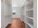 Expansive walk-in closet offers ample storage with custom shelving and a window for natural light at 1204 S Balsam Ct, Lakewood, CO 80232