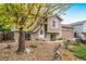 Two-story home with manicured landscaping and beautiful trees near the walkway at 1482 S Pitkin Cir, Aurora, CO 80017