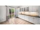 Bright kitchen featuring white cabinets, stainless steel appliances, and sliding door to backyard at 1482 S Pitkin Cir, Aurora, CO 80017