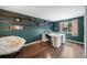 Home office showcasing hardwood floors, custom shelving, a spacious desk and modern chair with ample lighting at 1482 S Pitkin Cir, Aurora, CO 80017