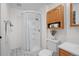 Bright bathroom featuring a glass-enclosed shower, wood cabinet, and decorative elements creating a cozy feel at 1188 Mulberry Ln, Highlands Ranch, CO 80129