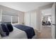 Comfortable bedroom with neutral tones, large window, and access to the home's living area at 1188 Mulberry Ln, Highlands Ranch, CO 80129