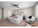 Cozy bedroom with a ceiling fan, accent chair, and a large comfortable bed at 1188 Mulberry Ln, Highlands Ranch, CO 80129