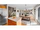 Adjacent to the kitchen, the dining area has updated light fixture and a view to the home's living area at 1188 Mulberry Ln, Highlands Ranch, CO 80129