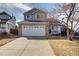 Charming two-story home with a brick-accented garage and well-manicured lawn in a friendly neighborhood at 1188 Mulberry Ln, Highlands Ranch, CO 80129