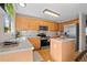 Bright kitchen features wood cabinets, stainless steel appliances and island, perfect for cooking and entertaining at 1188 Mulberry Ln, Highlands Ranch, CO 80129