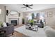 Comfortable living room with a fireplace, ample seating, and large windows, perfect for relaxation and gatherings at 1188 Mulberry Ln, Highlands Ranch, CO 80129