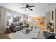 Open-concept living room connects seamlessly to the kitchen, featuring stylish decor, and abundant natural light at 1188 Mulberry Ln, Highlands Ranch, CO 80129