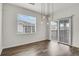 Bright dining area with modern pendant lighting and sliding glass door to the outdoor patio at 200 Whitehaven Cir, Highlands Ranch, CO 80129