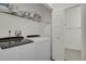 Convenient laundry room with washer, dryer, and shelving at 200 Whitehaven Cir, Highlands Ranch, CO 80129