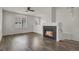 Bright living room with hardwood floors, a fireplace, and large windows providing ample natural light at 200 Whitehaven Cir, Highlands Ranch, CO 80129