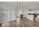 Open-concept living area featuring hardwood floors, fireplace, and a seamless flow to the kitchen at 200 Whitehaven Cir, Highlands Ranch, CO 80129