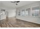 Bright living room with hardwood floors and large windows offering beautiful views at 200 Whitehaven Cir, Highlands Ranch, CO 80129