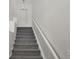 Carpeted staircase with white railing leading to the upper level at 200 Whitehaven Cir, Highlands Ranch, CO 80129