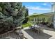 Spacious backyard featuring a patio, seating area, and mature trees at 12671 Home Farm Ln, Westminster, CO 80234