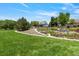 Expansive backyard with lush lawn, gardens, and mature trees at 12671 Home Farm Ln, Westminster, CO 80234