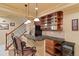 Finished basement features bar with stools, refrigerator, wine cooler, sink and storage at 12671 Home Farm Ln, Westminster, CO 80234