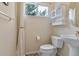 Bright bathroom featuring a pedestal sink, medicine cabinet, and window providing natural light at 12671 Home Farm Ln, Westminster, CO 80234
