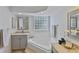 Bathroom features a relaxing soaking tub, glass block window, and vanity space at 12671 Home Farm Ln, Westminster, CO 80234