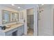 Bright bathroom features walk-in shower, granite countertops, and vanity area at 12671 Home Farm Ln, Westminster, CO 80234
