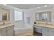 Relaxing bathroom with soaking tub, glass block window, and double sinks with vanity at 12671 Home Farm Ln, Westminster, CO 80234