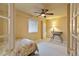 Cozy bedroom with a ceiling fan, marble-topped side table, and natural light at 12671 Home Farm Ln, Westminster, CO 80234