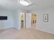 Comfortable bedroom showcasing closet, carpet floors, tv and access to other living spaces at 12671 Home Farm Ln, Westminster, CO 80234