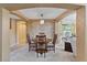 Elegant dining room with an arched entry, stylish chandelier, stone accent wall, and seamless access to the kitchen at 12671 Home Farm Ln, Westminster, CO 80234