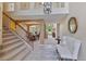 Open concept entryway featuring tile flooring, a staircase, a view of the living areas, and natural light at 12671 Home Farm Ln, Westminster, CO 80234
