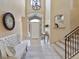 Grand foyer featuring tile floors, a staircase, soaring ceilings, and natural light creating an inviting ambiance at 12671 Home Farm Ln, Westminster, CO 80234