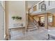 Inviting entryway with tile flooring, showcasing the staircase, open floor plan, and decorative lighting fixtures at 12671 Home Farm Ln, Westminster, CO 80234