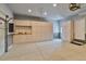 Garage featuring built-in cabinets and plenty of storage space and epoxy flooring at 12671 Home Farm Ln, Westminster, CO 80234