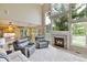 Spacious living area featuring a fireplace, large windows, and comfortable seating, complemented by an open layout at 12671 Home Farm Ln, Westminster, CO 80234