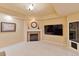 Inviting living room with fireplace, mounted TV, and neutral carpet at 12671 Home Farm Ln, Westminster, CO 80234