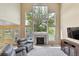 Bright living room with a soaring ceiling, large windows, a fireplace, and comfortable seating at 12671 Home Farm Ln, Westminster, CO 80234