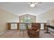 Relaxing loft space with vaulted ceiling, ceiling fan, seating area, and views of the outside at 12671 Home Farm Ln, Westminster, CO 80234