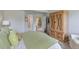 Spacious main bedroom features hardwood armoire and view to entryway at 12671 Home Farm Ln, Westminster, CO 80234