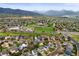 Scenic aerial view showcasing a residential community with green spaces and mountain views in the background at 7927 Elmwood St, Littleton, CO 80125