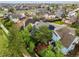 Neighborhood aerial view with lush trees surrounding suburban homes with lawns at 7927 Elmwood St, Littleton, CO 80125